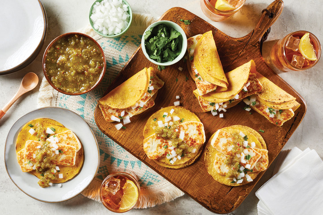 aerial shot of tacos with salsa and garnishes